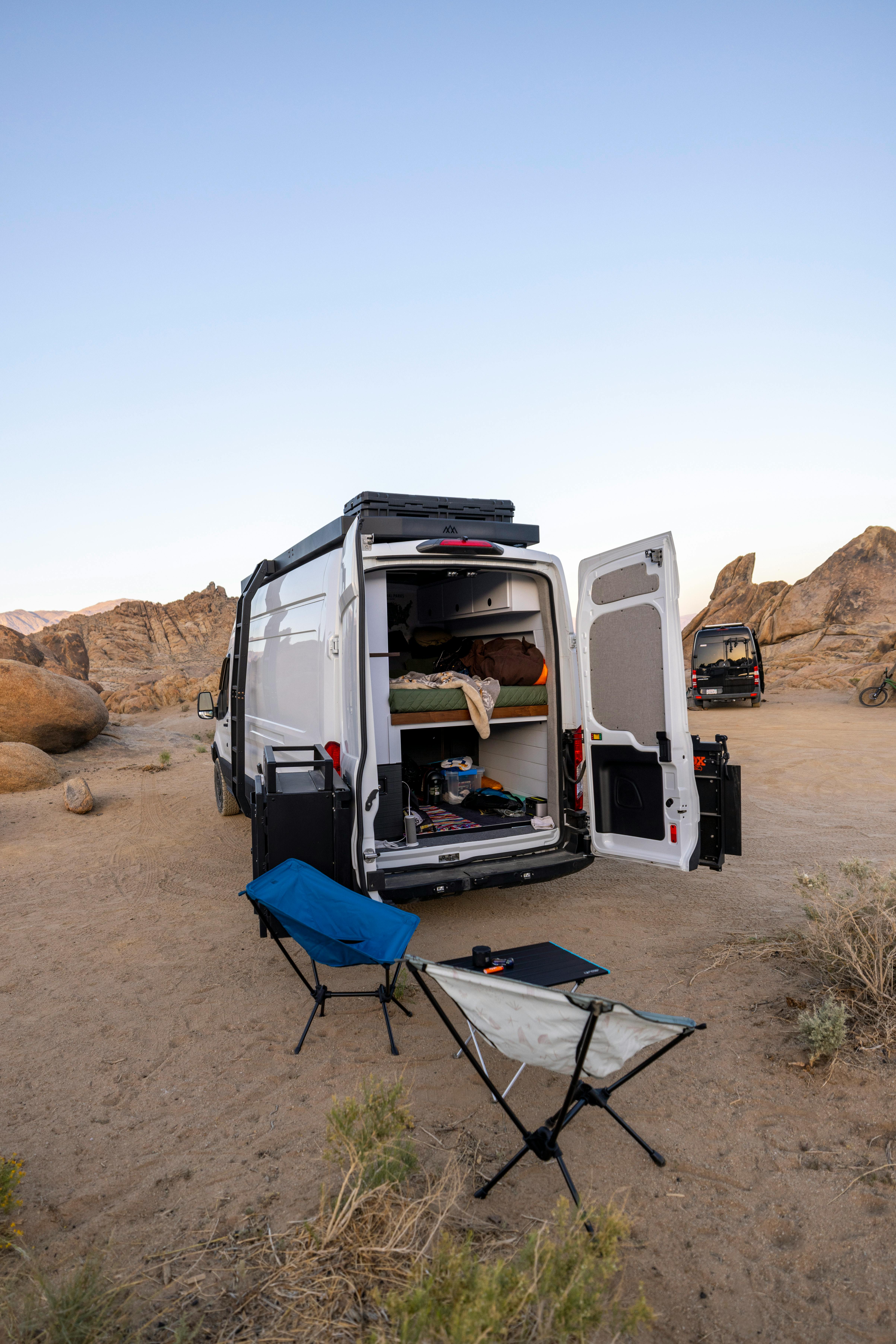 Explore outdoor freedom with a camper van setup in a serene desert landscape. Perfect for travel enthusiasts.