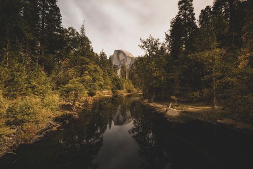 Free Stunning autumn landscape of Half Dome with tranquil water reflection in Yosemite National Park. Stock Photo