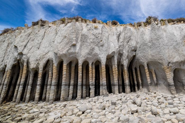 Coastal basalt rock formations under a clear blue sky, photo by Stephen Leonardi on Pexels