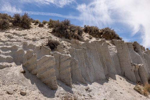 Free Eroded sandy cliffs under a bright blue sky showcasing impressive geological formations. Stock Photo