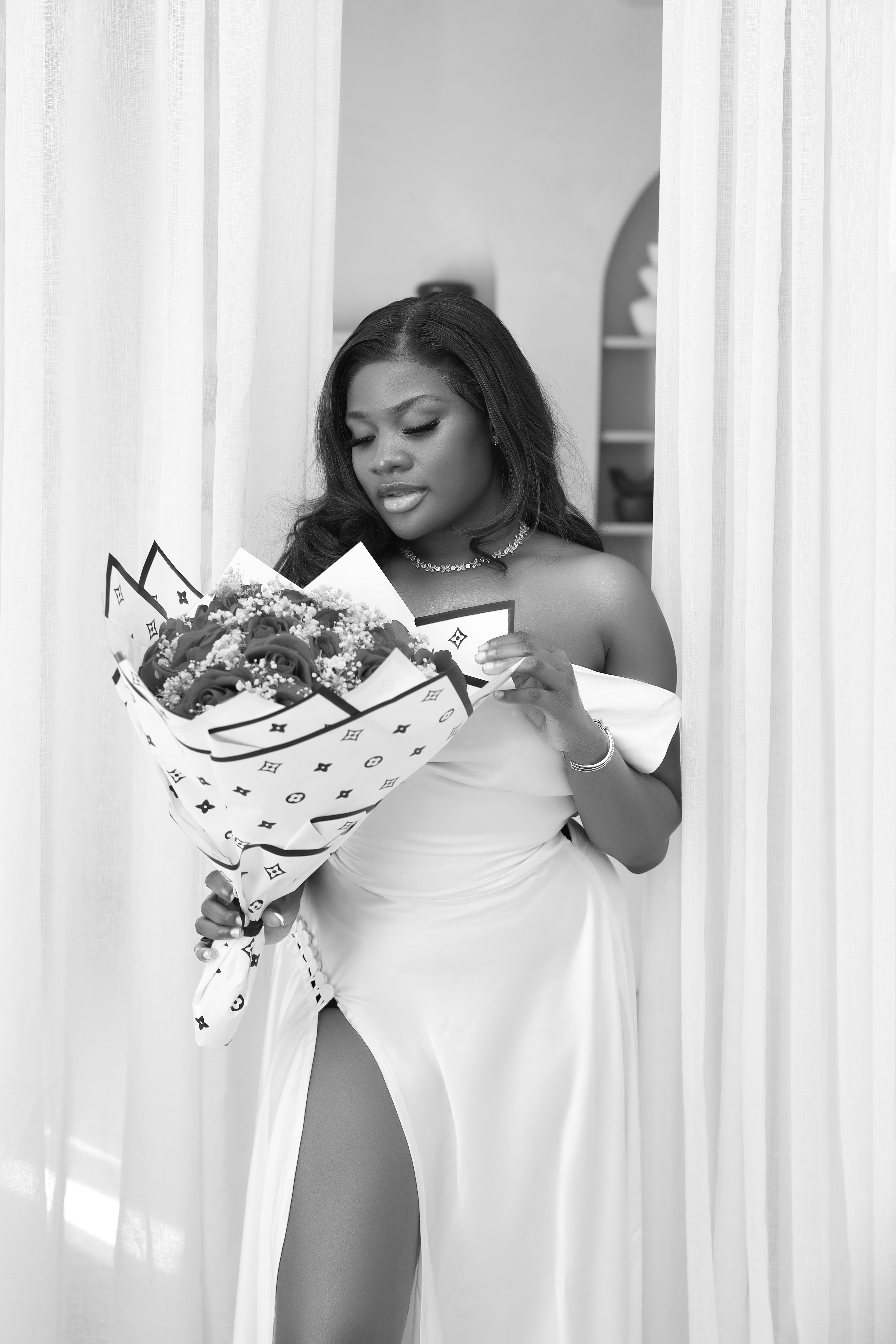 Elegant Woman Holding Bouquet in Black and White · Free Stock Photo