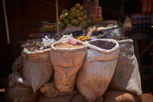 Colorful display of spices and herbs at an outdoor market in Zaria, Nigeria.