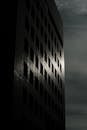 Silhouetted Skyscraper Against Moody Sky