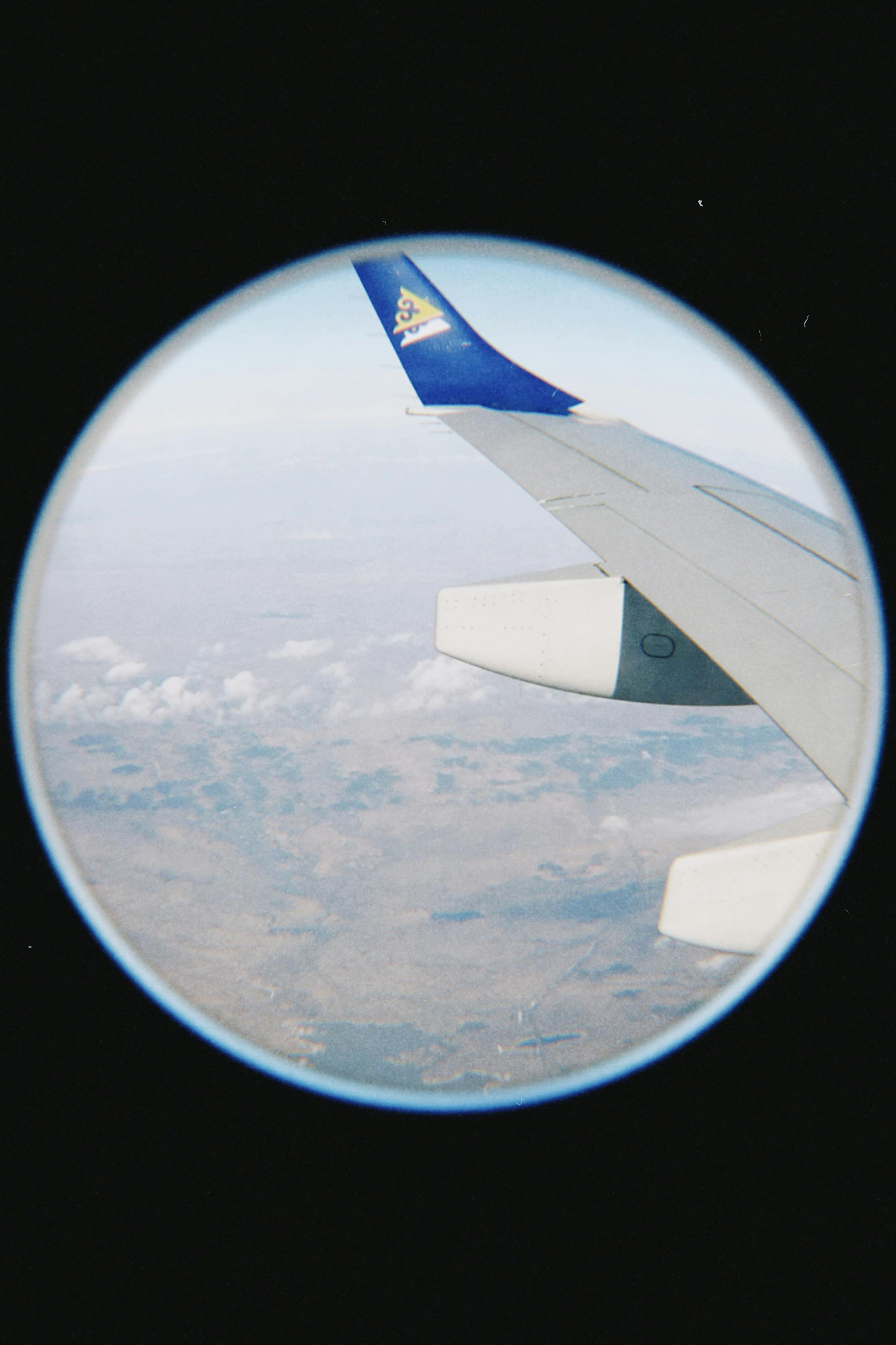 Airplane wing view over Kazakhstan's landscape with clear skies.