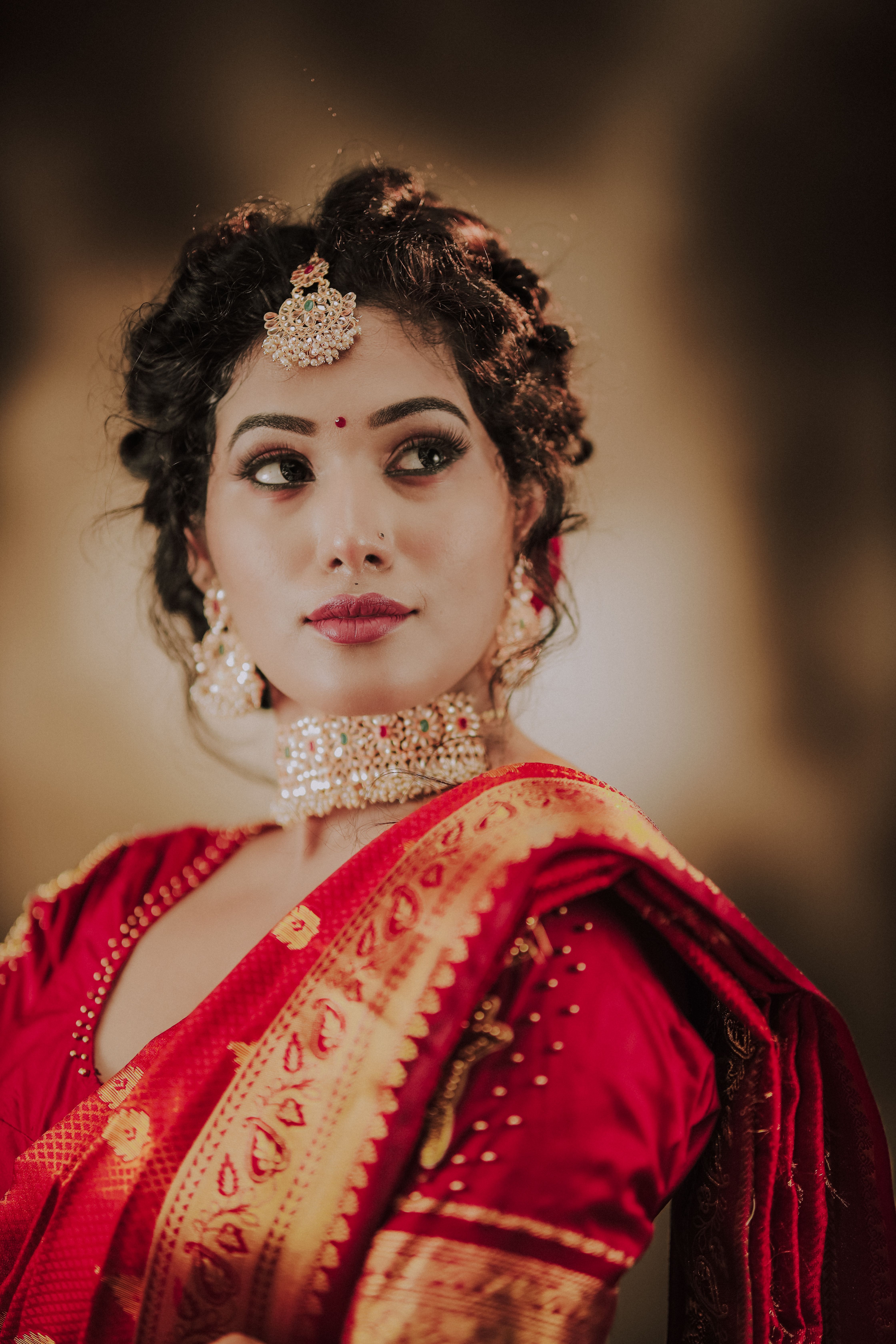 Portrait of a woman in traditional Indian bridal wear exuding elegance and grace.