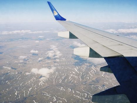 Scenic view of Kazakhstan's landscape from airplane, capturing the vast terrain below.