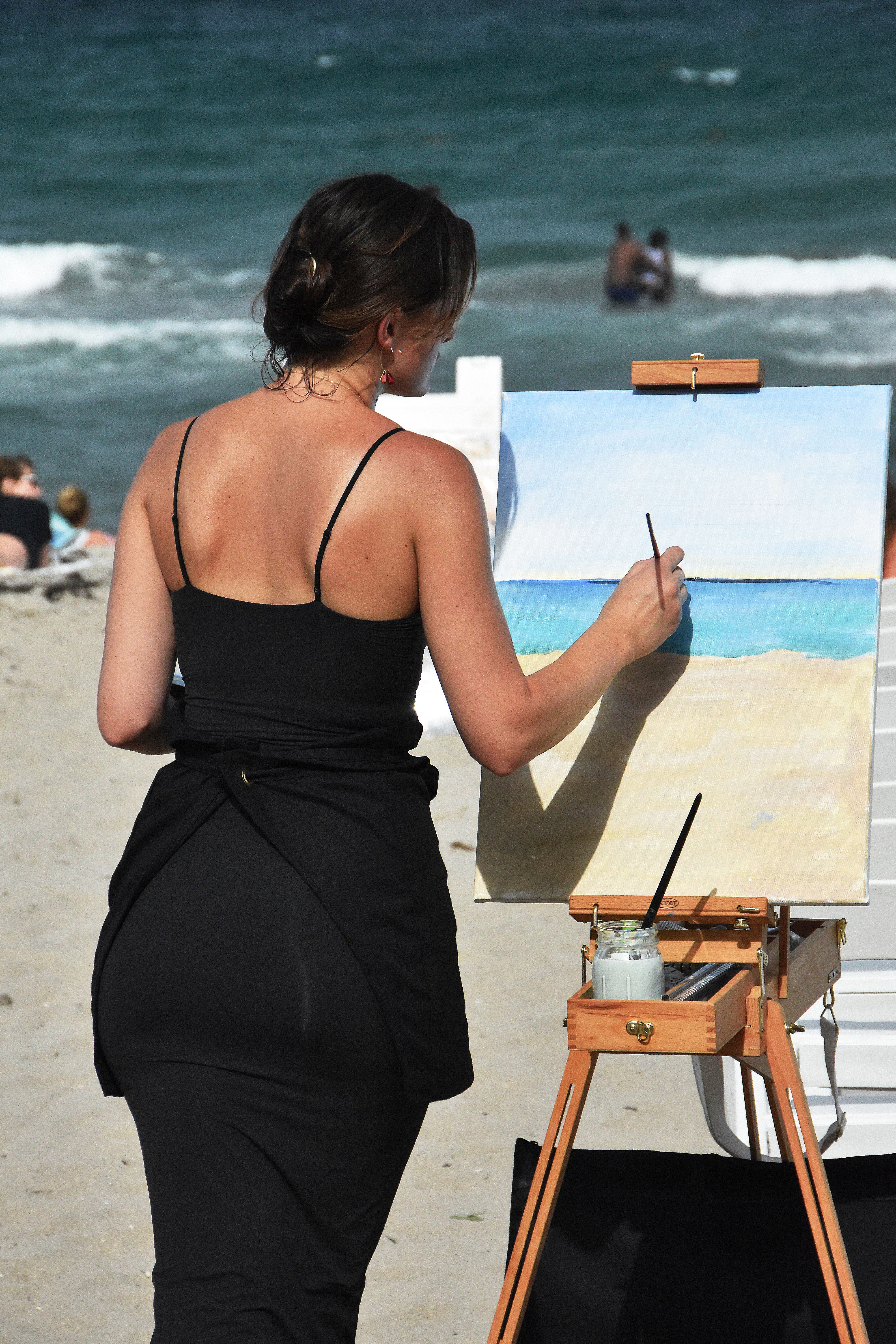 Woman painting seascape on a sunny beach · Free Stock Photo