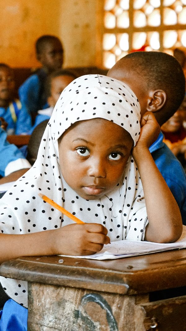 A young student writing in class