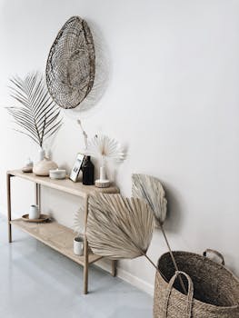 Stylish minimalist interior with woven baskets and dried palms for decoration.