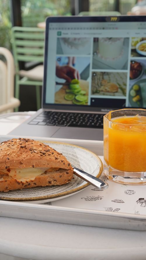 Free A tasty seeded sandwich paired with a refreshing orange juice at a cozy cafe setting. Stock Photo