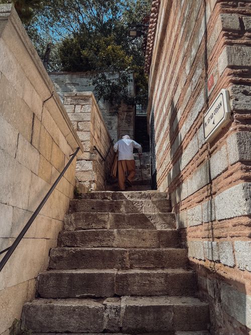 Free Man climbing stone staircase in historic architectural setting. Stock Photo