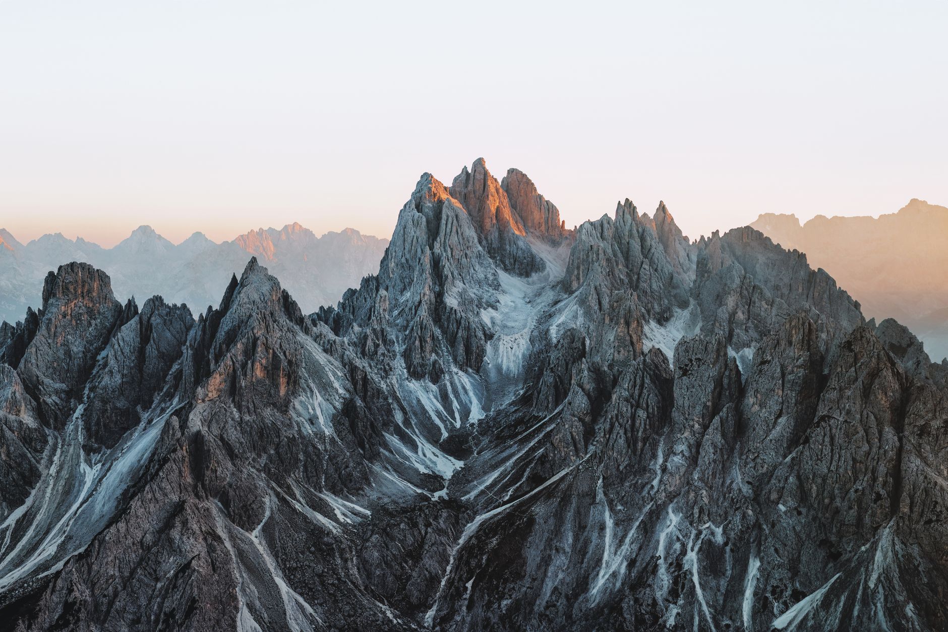 Breathtaking view of the Dolomites' jagged peaks bathed in sunset light.