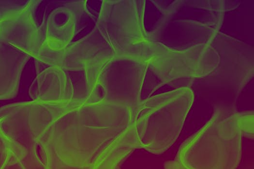 Colorful abstract art featuring swirling green smoke on a dark background, perfect for wallpapers.