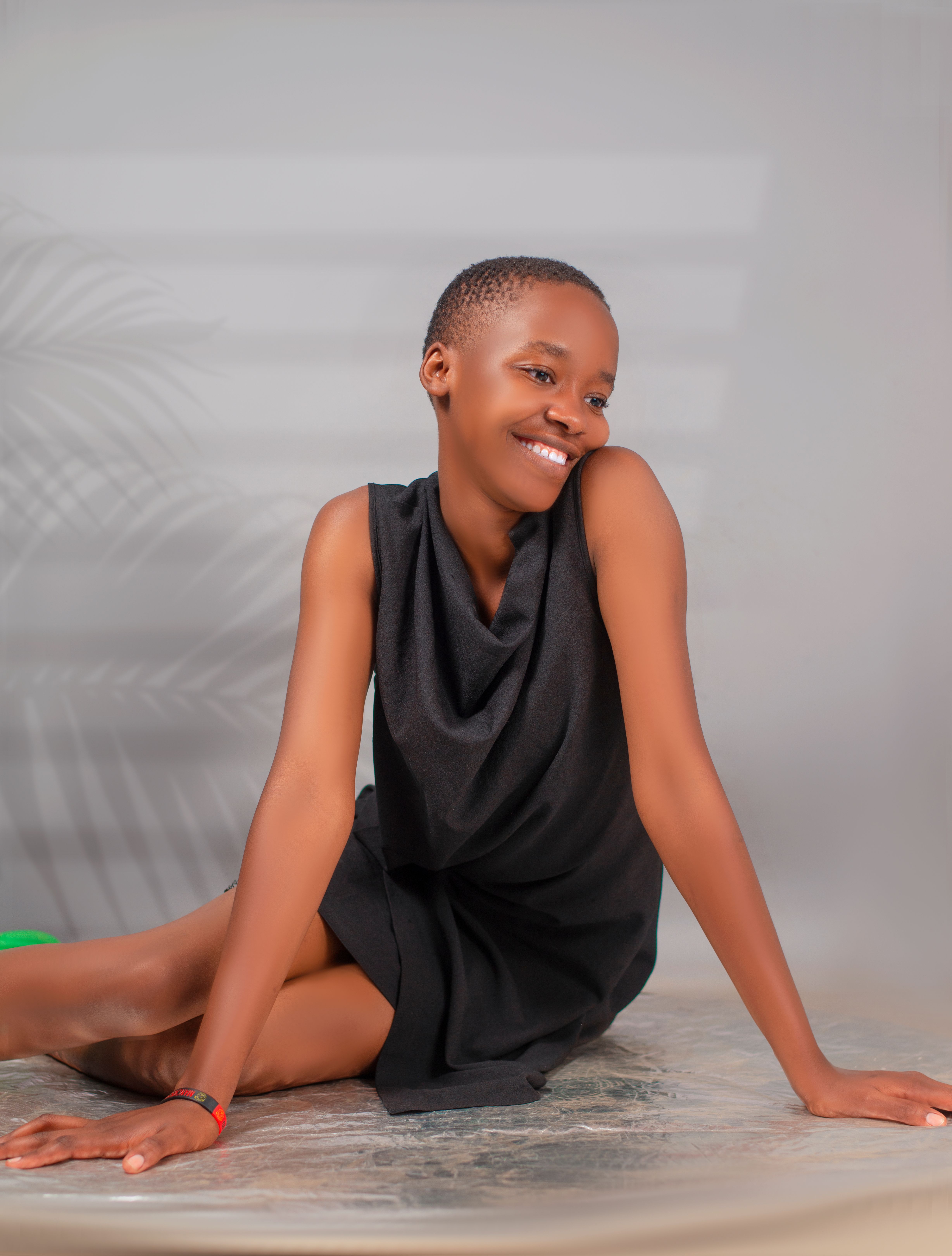 Smiling Woman in Black Dress Indoors · Free Stock Photo