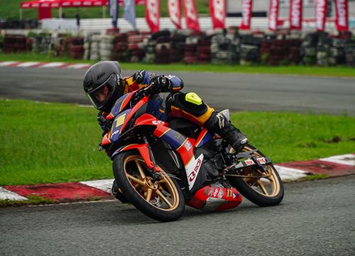 Free Thrilling motorcycle racer leaning into a curve on a race track in Tarlac City, Philippines. Stock Photo