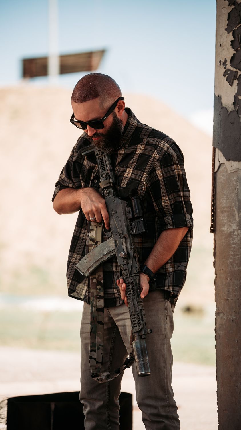 Man With Rifle Man with Tactical Rifle Outdoors in Casual Attire · Free Stock Photo