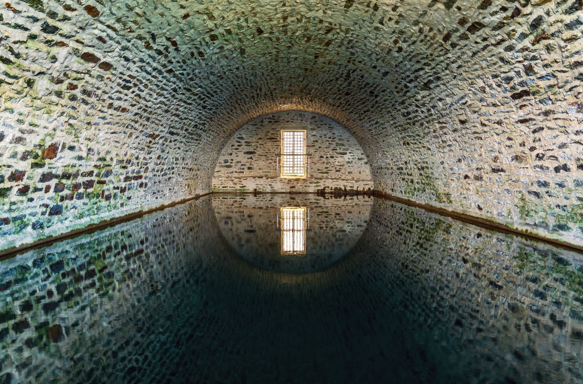 Serene Underground Stone Tunnel Reflections