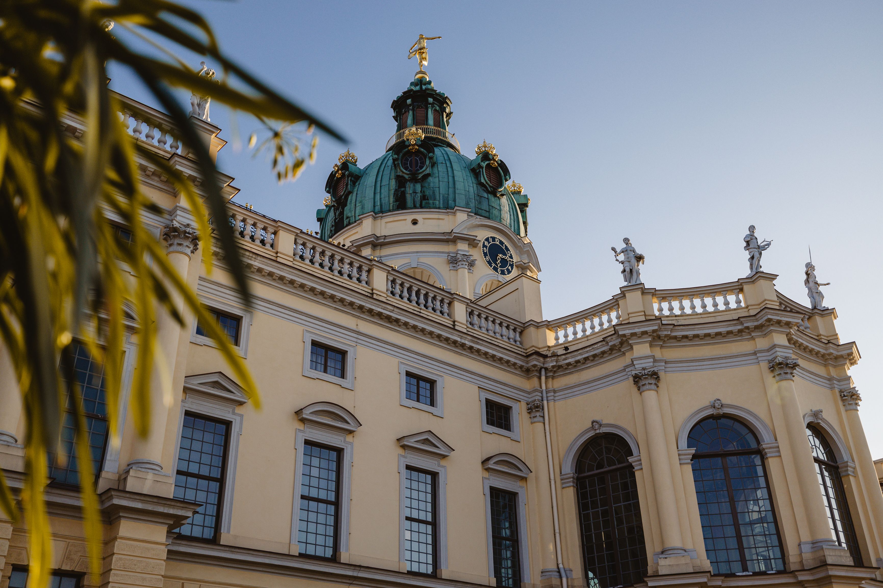A view of Charlottenburg Palace in Berlin with its ornate architecture captured at sunset.
