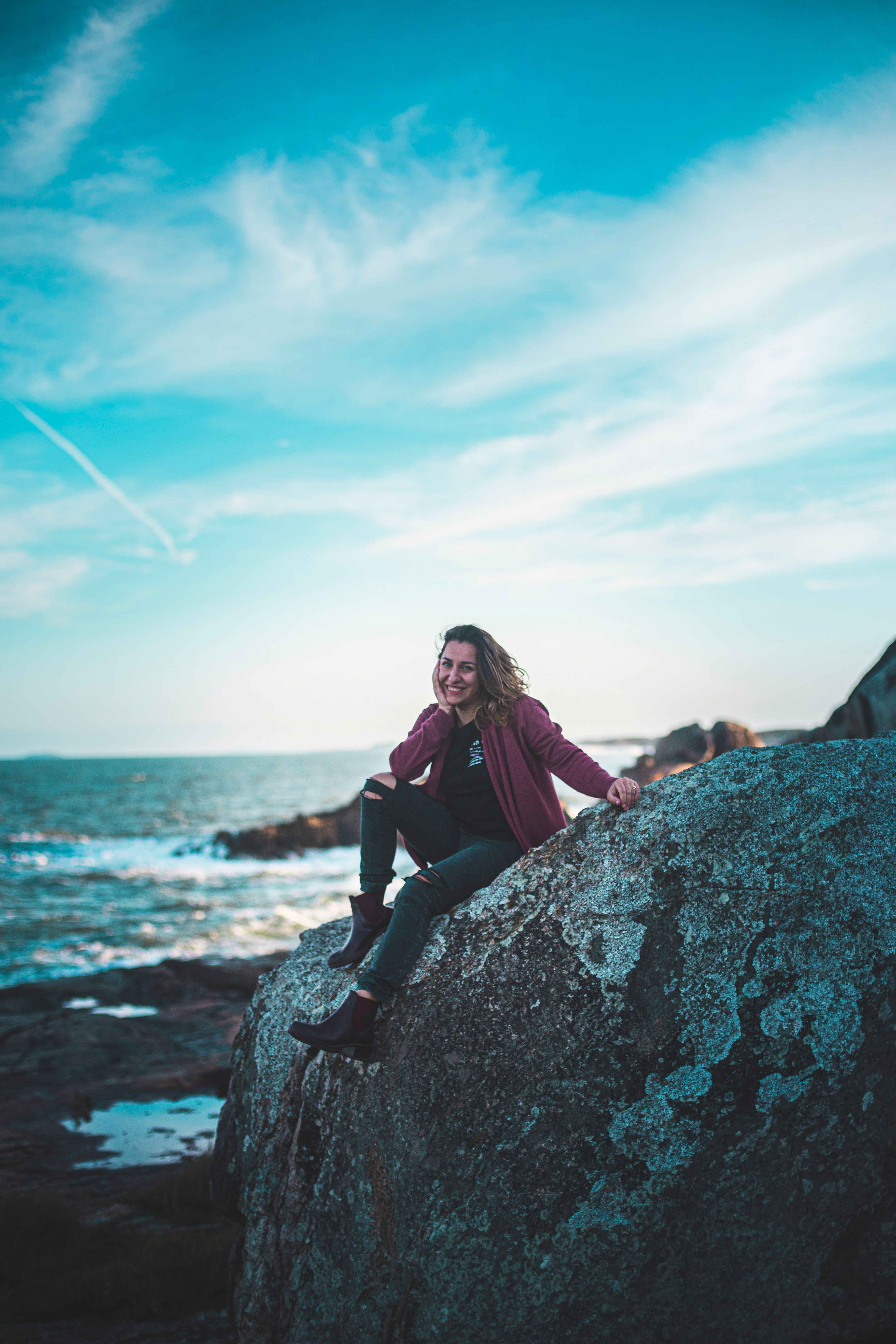 Photo Of Woman Sitting On Top Of The Rock · Free Stock Photo
