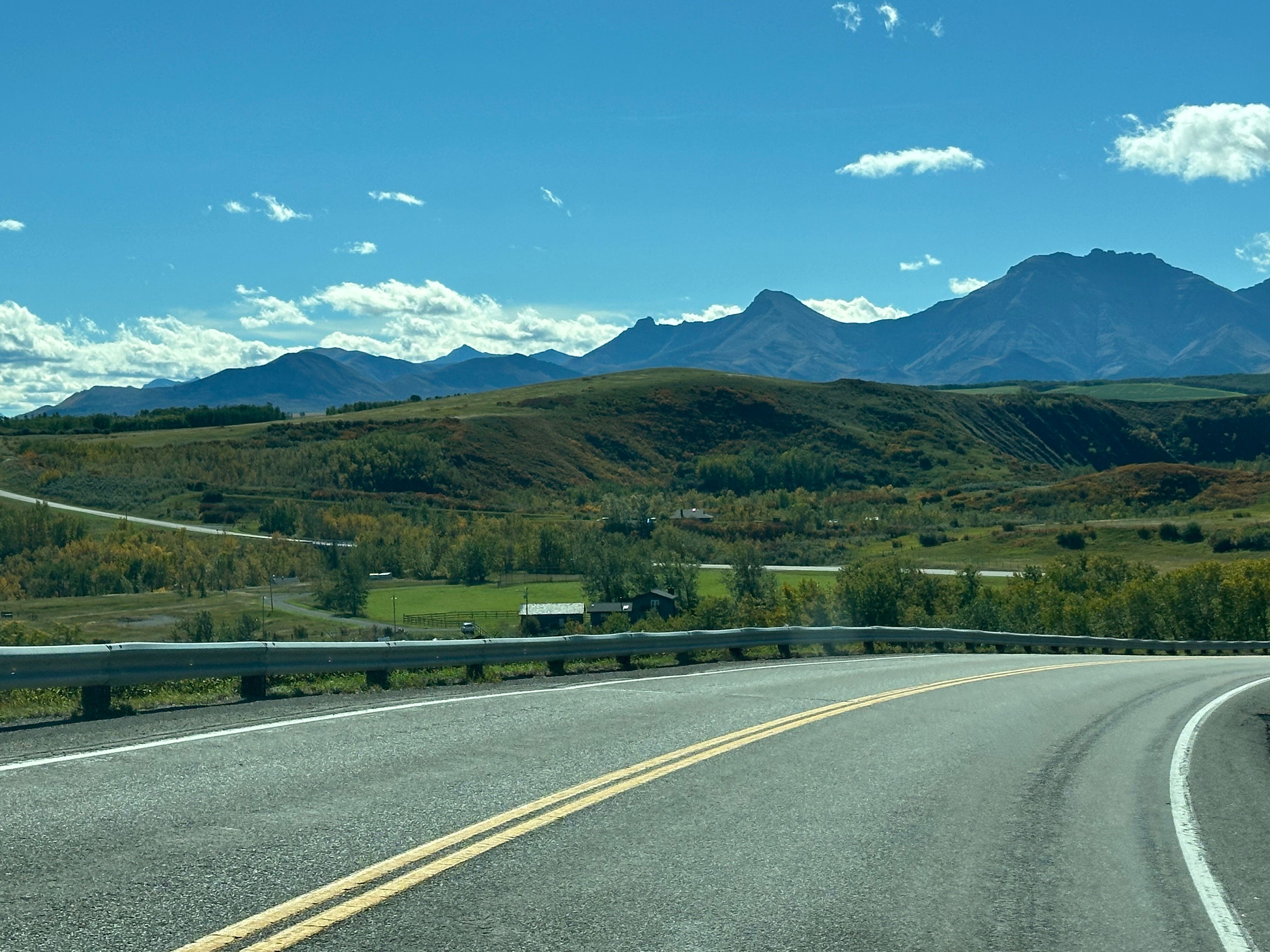 Scenic Mountain Road Under Clear Blue Sky · Free Stock Photo