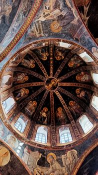 Capture of a richly decorated Byzantine dome showcasing historical frescoes and architectural details.