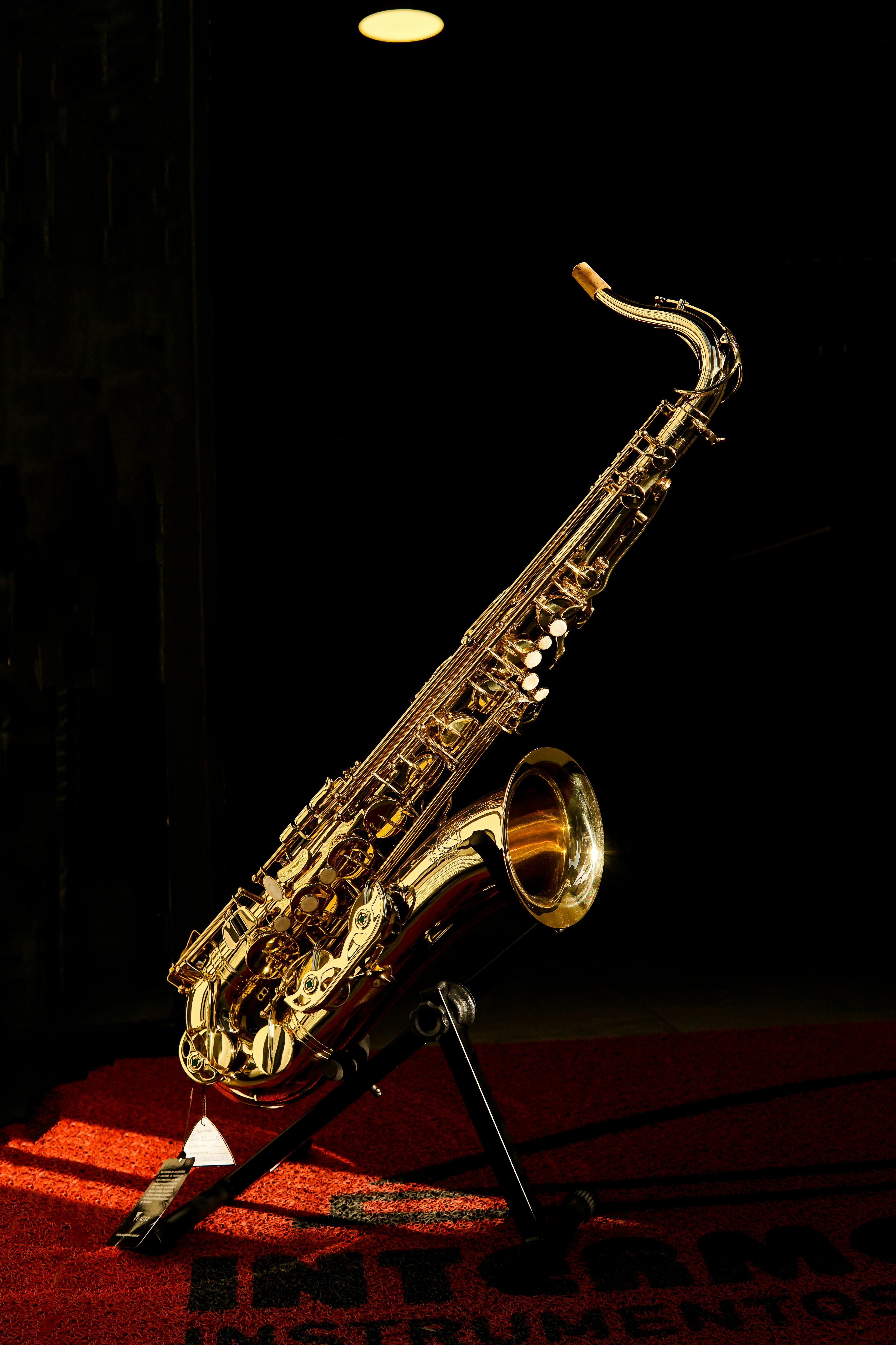 Elegant Saxophone on Stand in Dim Light · Free Stock Photo, image size:3832x5748