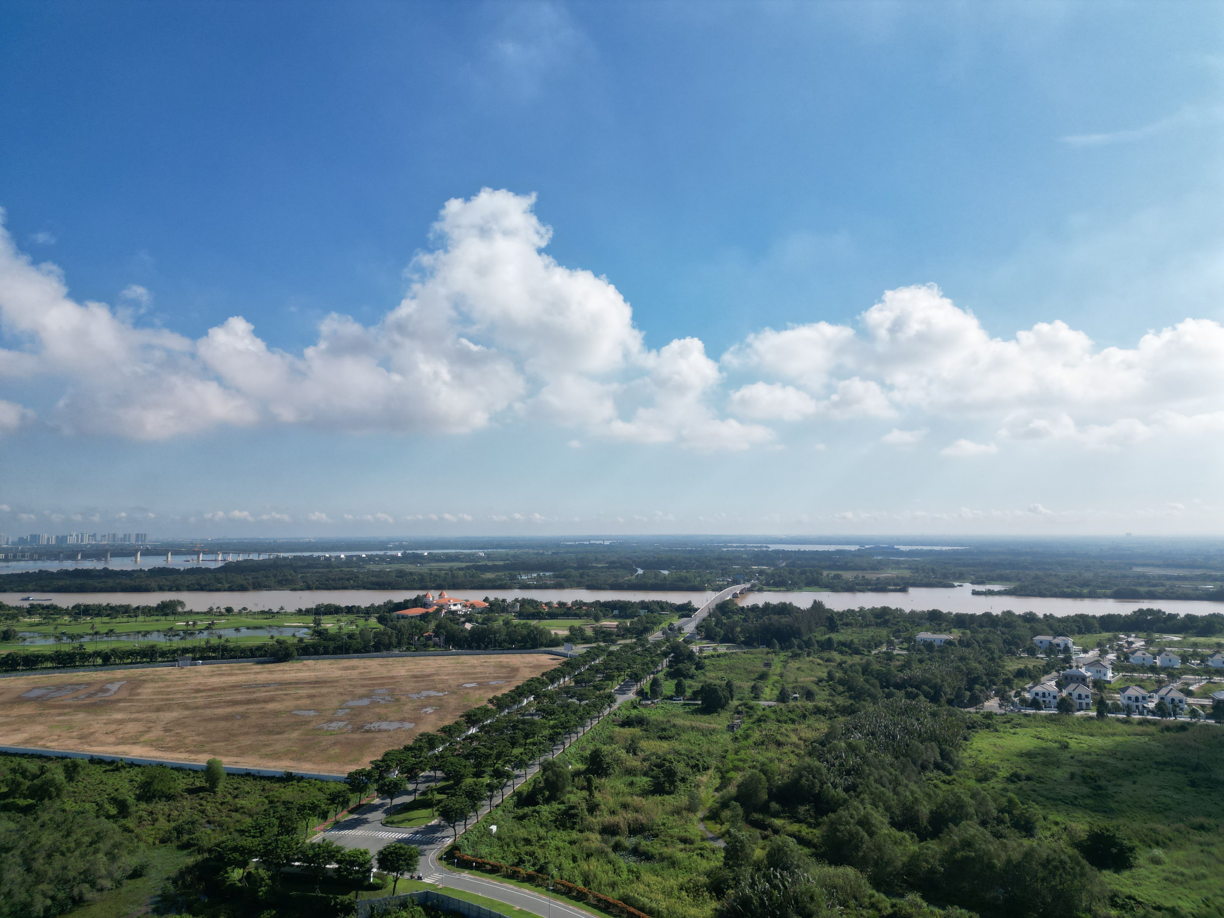 A breathtaking aerial view of Dong Nai's lush countryside under a bright blue sky.
