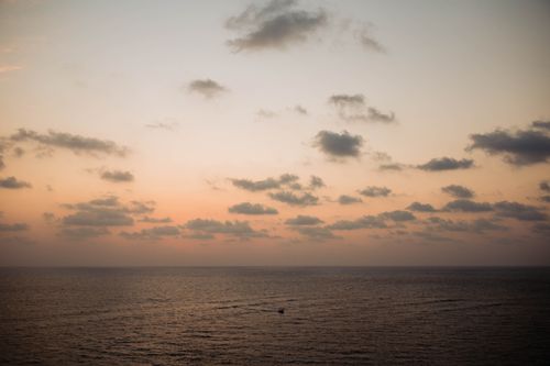 Free Tranquil sunset over Chapora Beach with pastel skies and gentle waves. Stock Photo