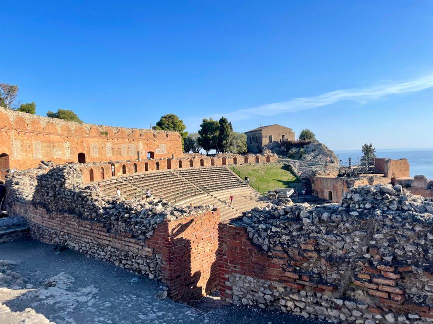 Explore the ancient Greek Theatre in Taormina, Sicily with stunning Mediterranean views.