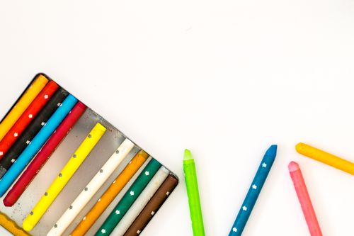 Free A vibrant array of colorful crayons displayed against a white background, perfect for art and creativity concepts. Stock Photo