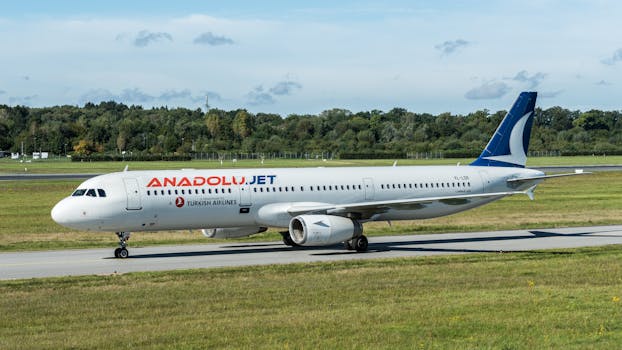 AnadoluJet Airbus A321 on the runway at Hamburg Airport, showcasing aviation and travel.