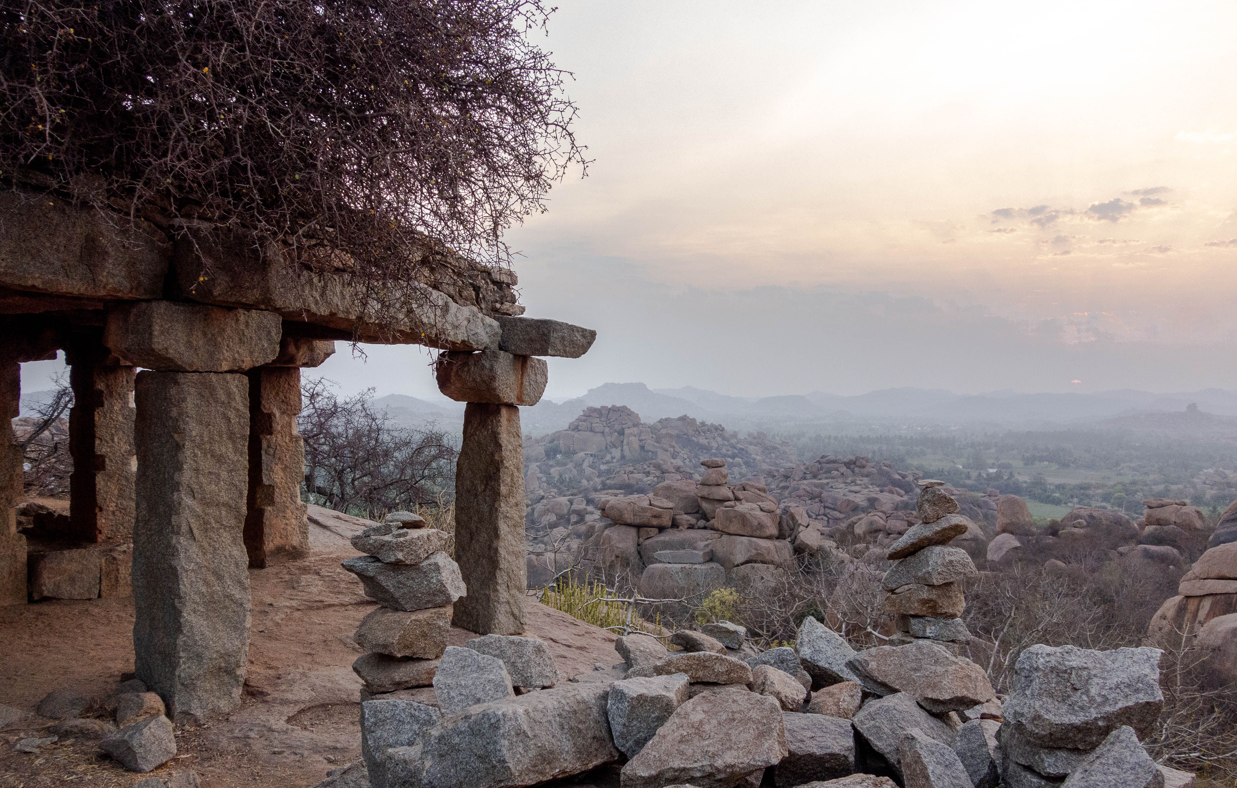 Sunset over ancient stone ruins on the Deccan plateau in Karnataka, India, evoking the landscape around Gurmitkal