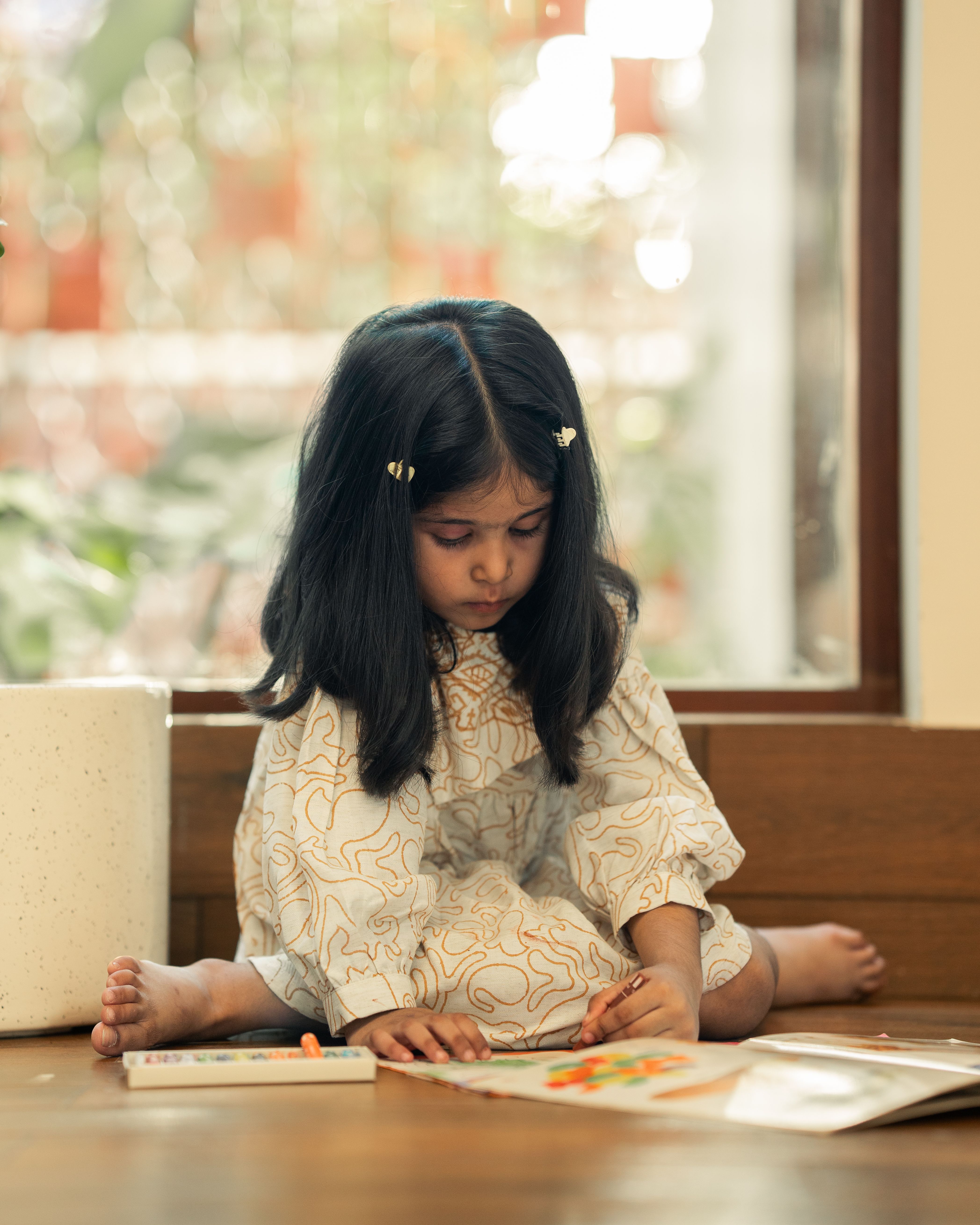 Young Girl Engaged in Coloring Activity Indoors · Free Stock Photo