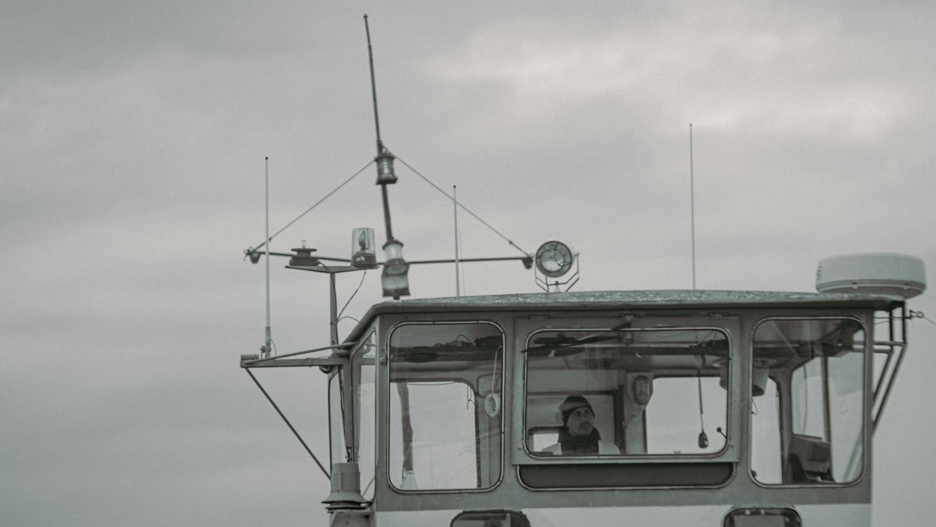 Captain on Ship's Bridge Navigating the Sea