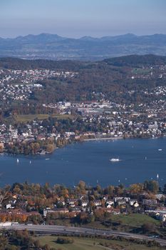 A stunning aerial view of Zurich Lake and scenic cityscape with mountains in the background.