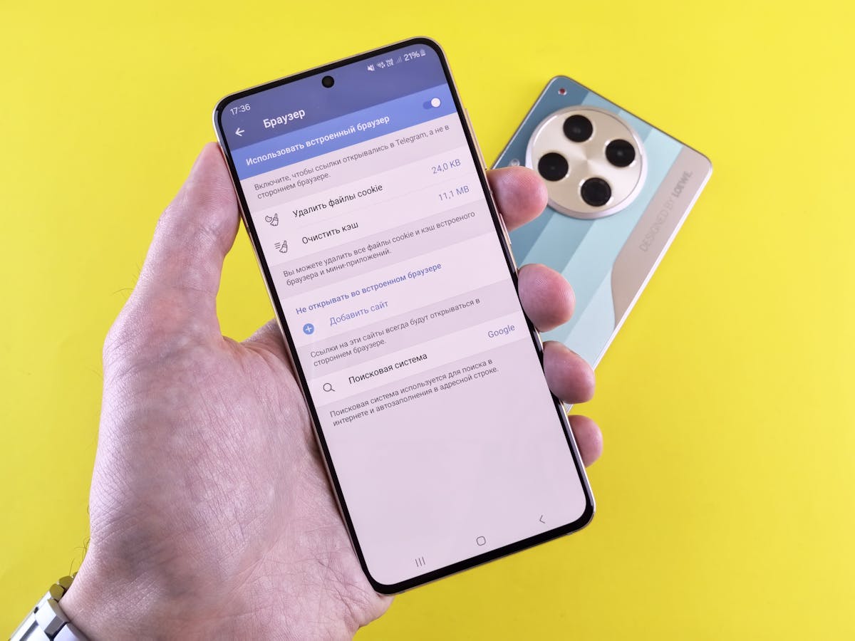 Primo piano di mano che tiene smartphone con schermata impostazioni leggibile