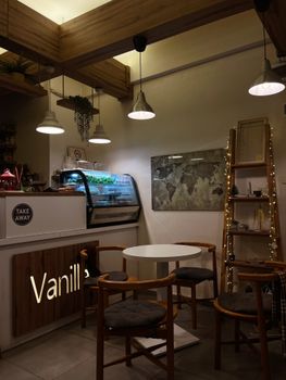 A stylish modern café interior with chic seating and subtle ambient lighting.