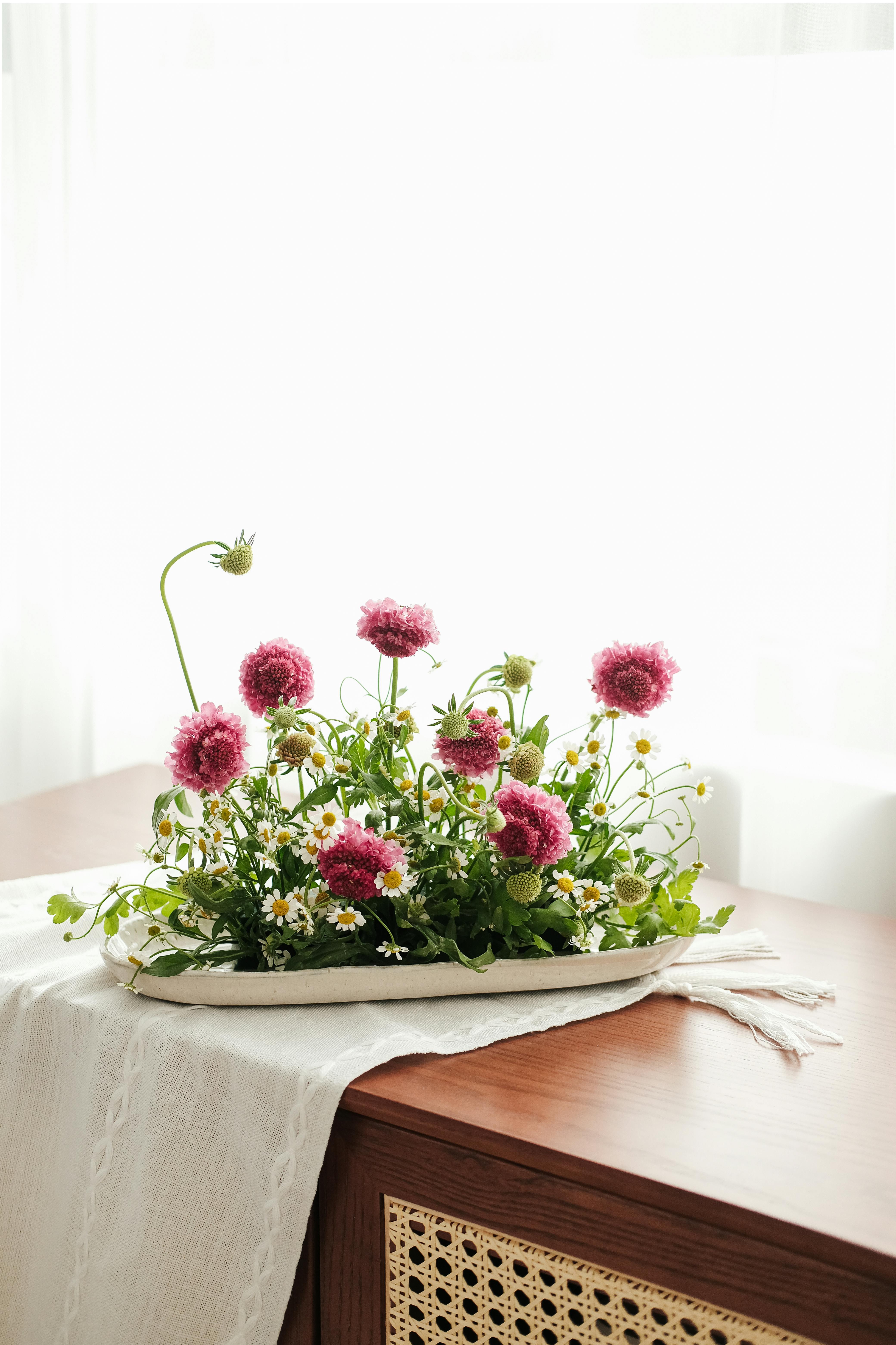 A stunning floral arrangement with pink and white blossoms on a wooden table, Hà Nội, Việt Nam.