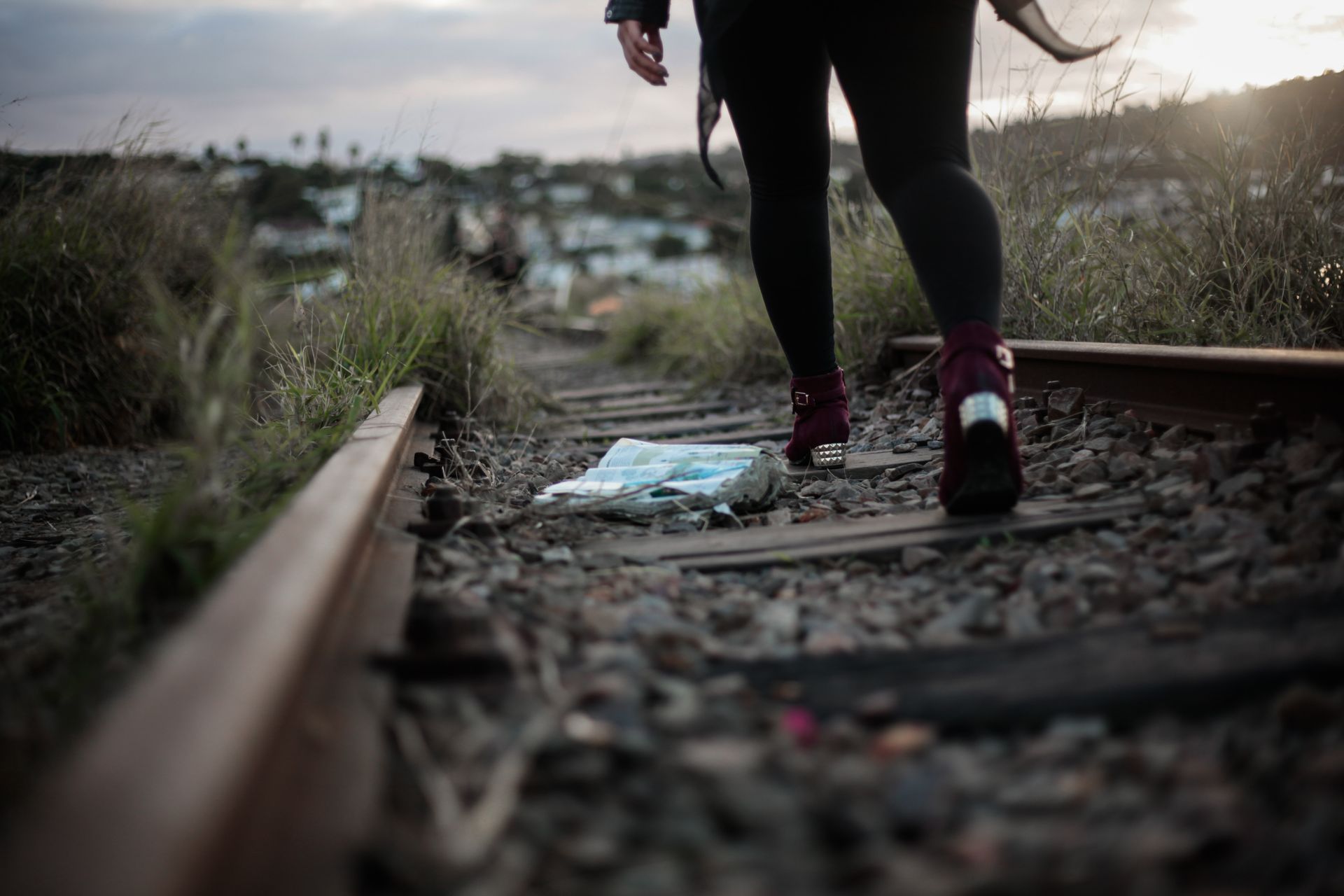 A person exploring along deserted railroad tracks at sunset in Johannesburg, South Africa.