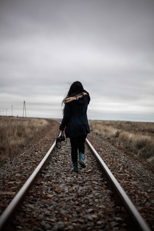 Free Woman Walking in Middle of Railway Stock Photo