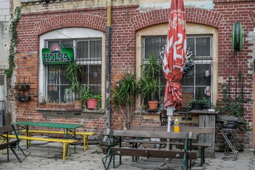 Cozy outdoor seating area with distinctive brick facade in Wrocław, Poland.
