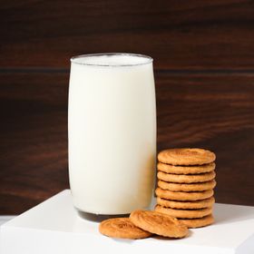 A glass of milk beside a stack of cookies — photo by ALOK DAS on Pexels