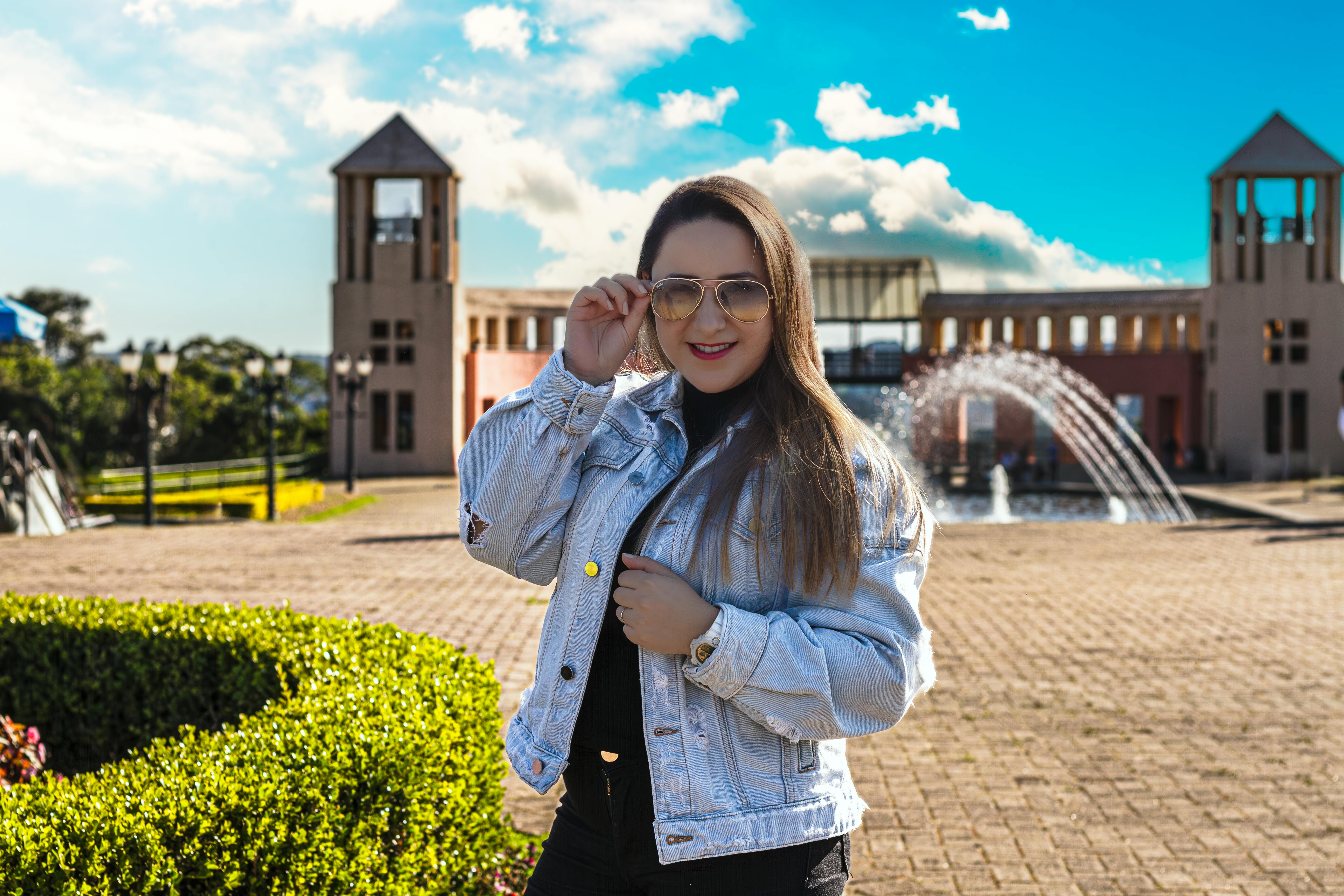 fashionable woman posing outdoors in sunshine