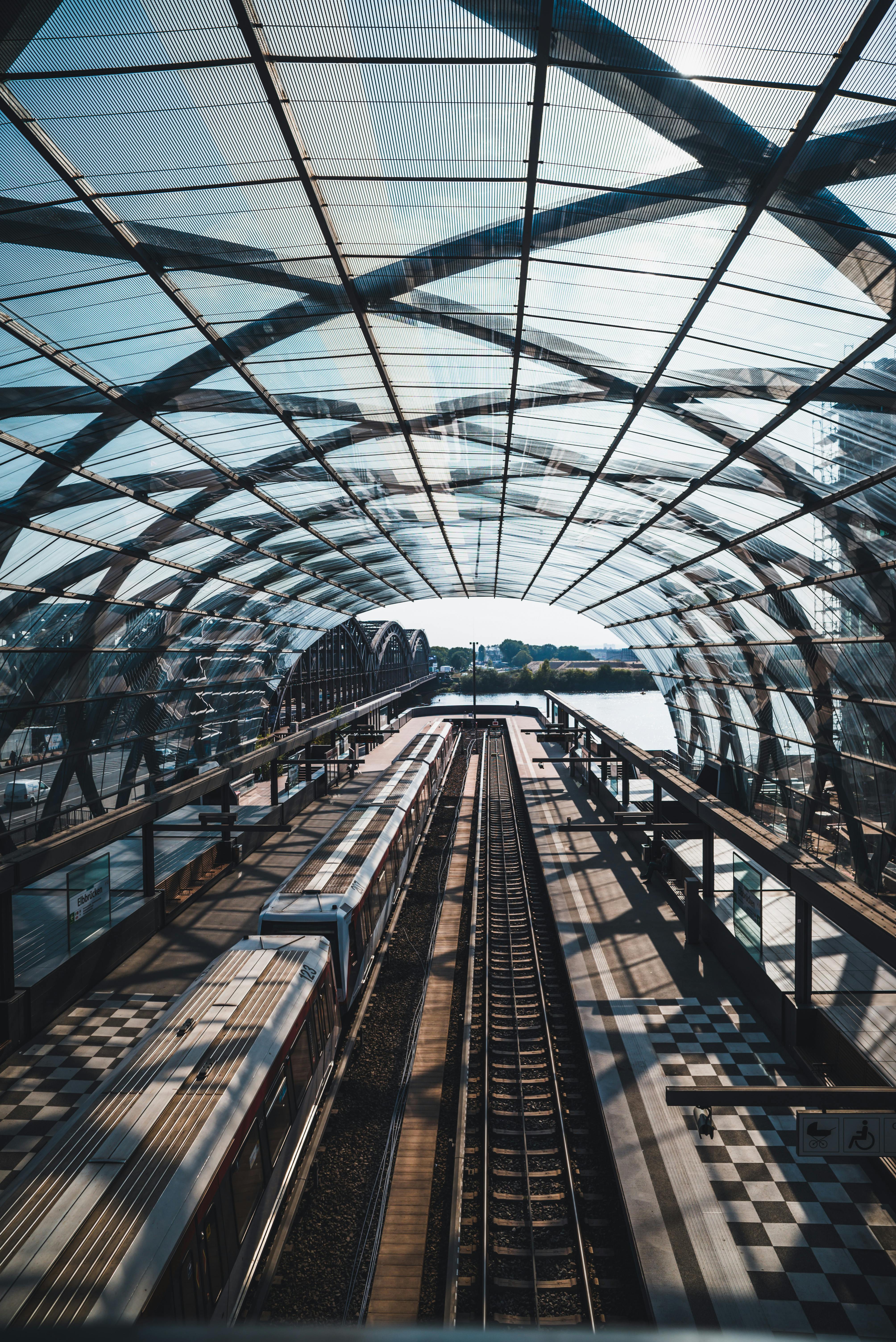 Architectural view of an urban train station in Hamburg, Germany, showcasing modern glass and steel design.
