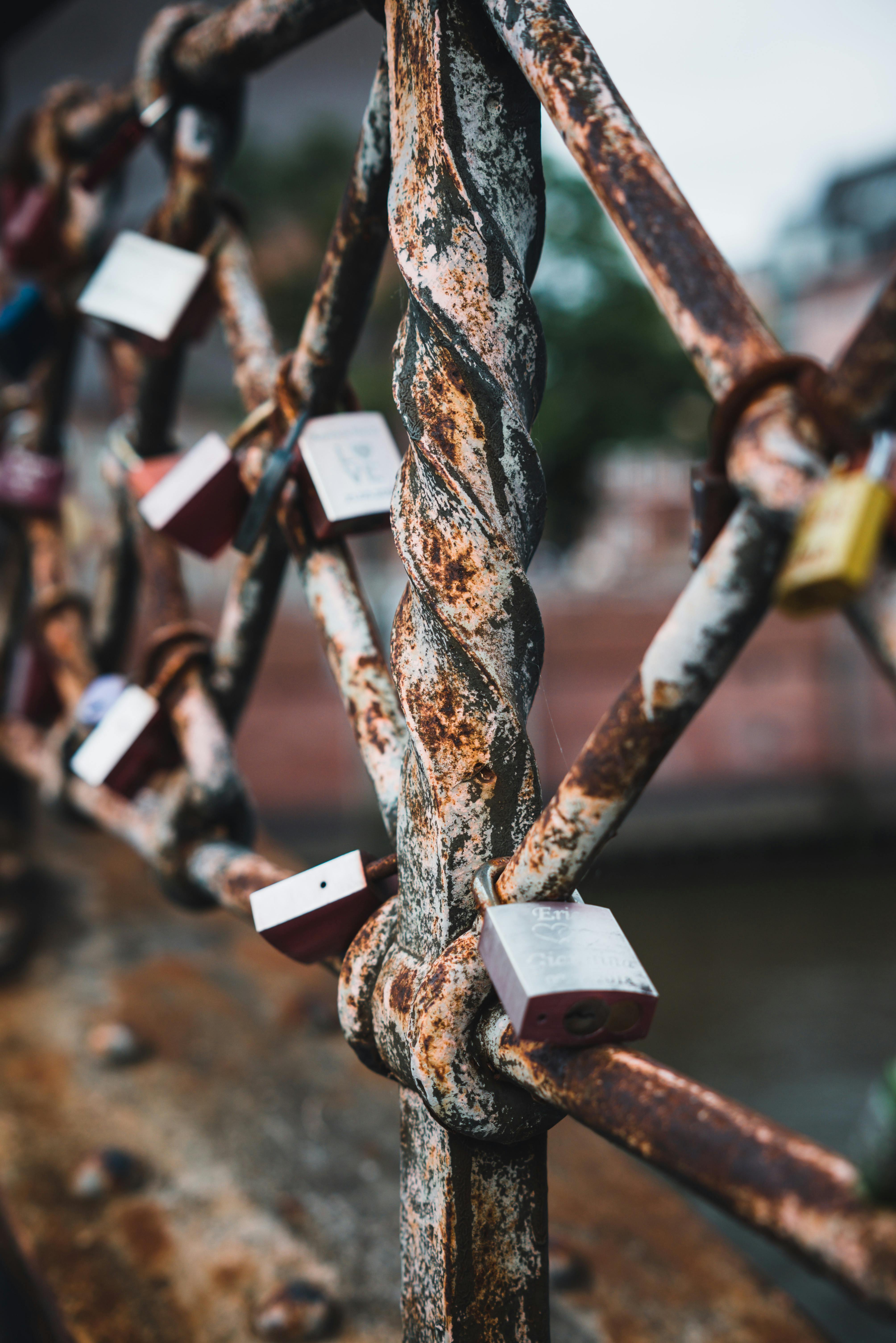 Close-up of rusty love locks on a bridge in Hamburg, symbolizing enduring love and commitment.