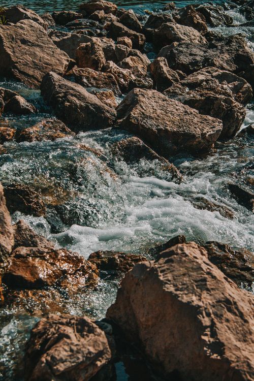 Free Flowing stream over rocks in Bashkortostan during autumn, capturing nature's peaceful beauty. Stock Photo