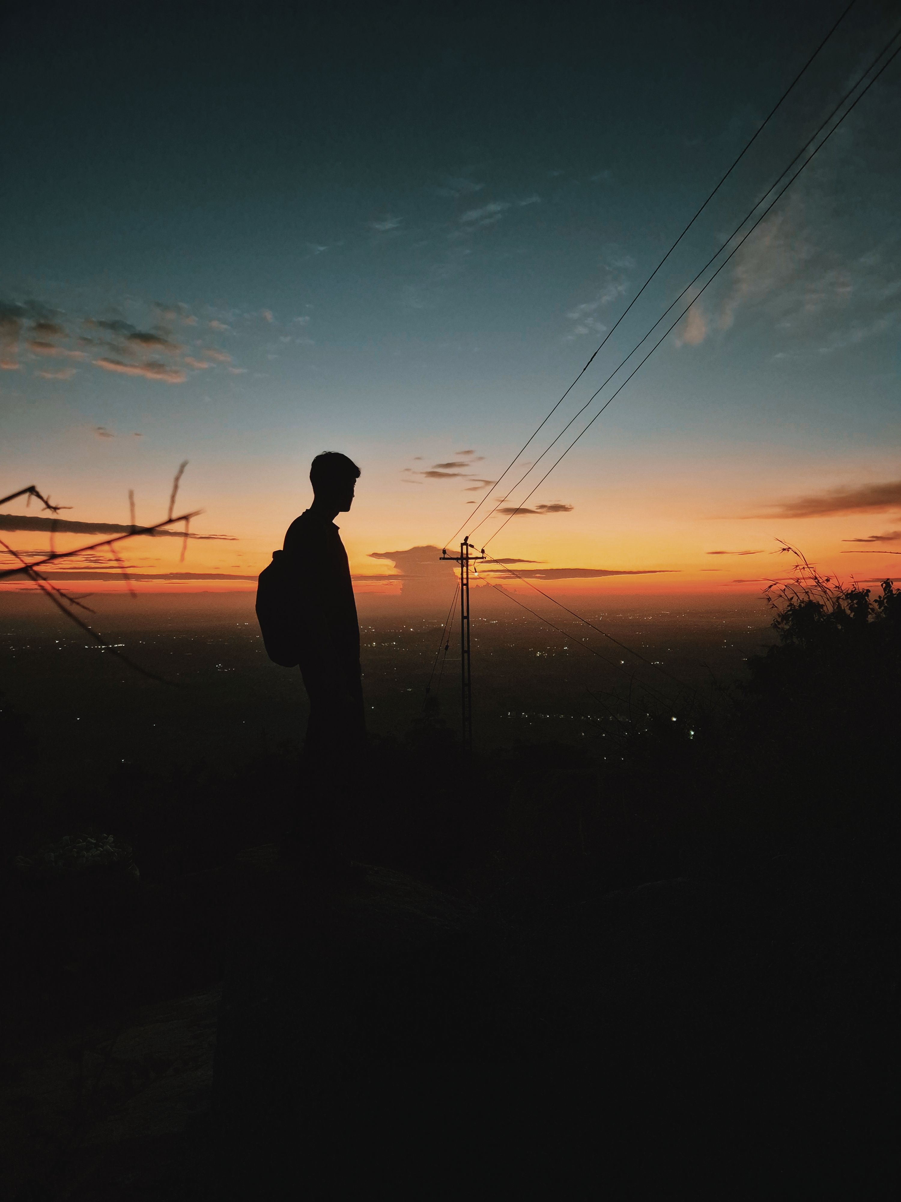 A captivating silhouette of a person at sunset with a vibrant sky above.. captivating, silhouette, person