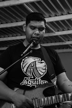 Engaging black and white image of a guitarist performing passionately in Mexico.