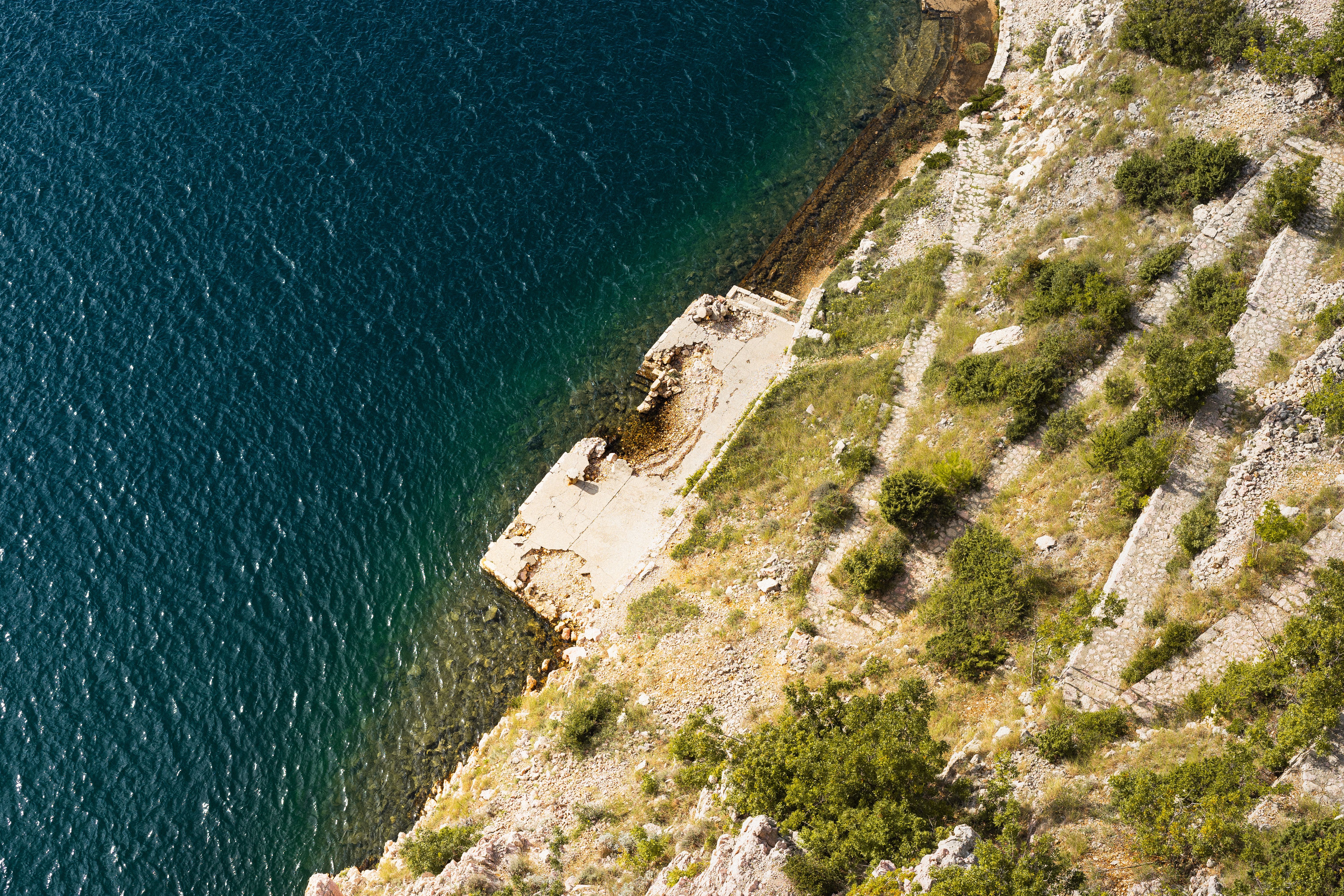 Aerial View of Rocky Coastline and Blue Sea · Free Stock Photo