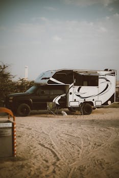 Discover a serene camping setup with an RV in Dubai's desert landscape, perfect for adventure lovers.